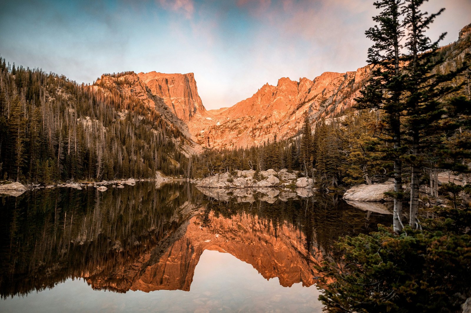 Dream Lake reflecting mountain cliffs at sunrise