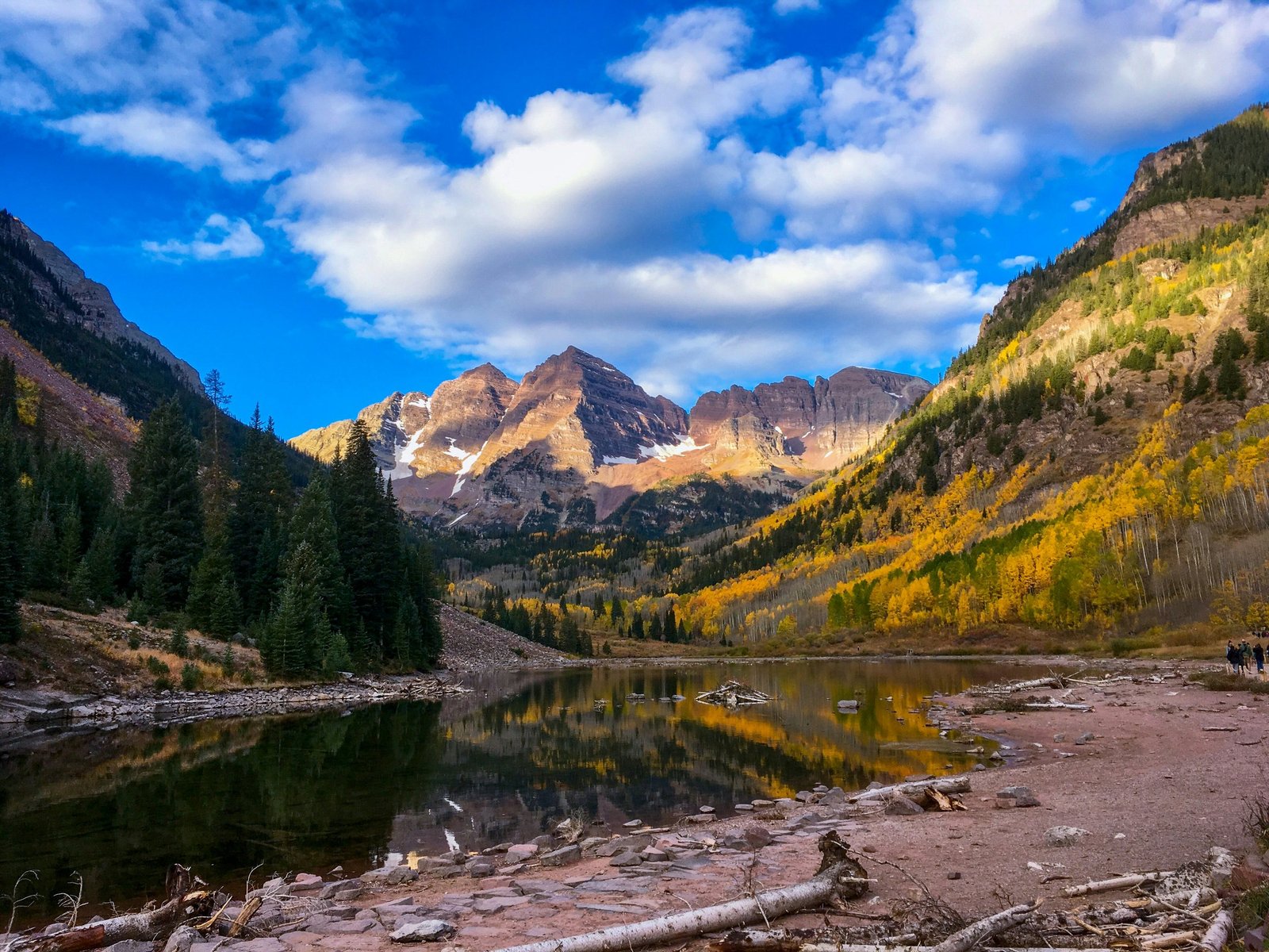Maroon Bells and autumn aspens reflected in a lake